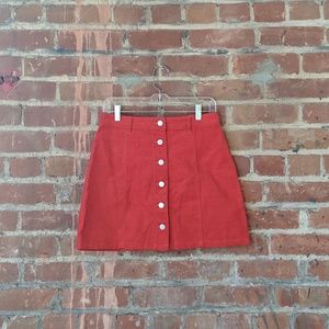 Boohoo  Red Corduroy skirt with button details.